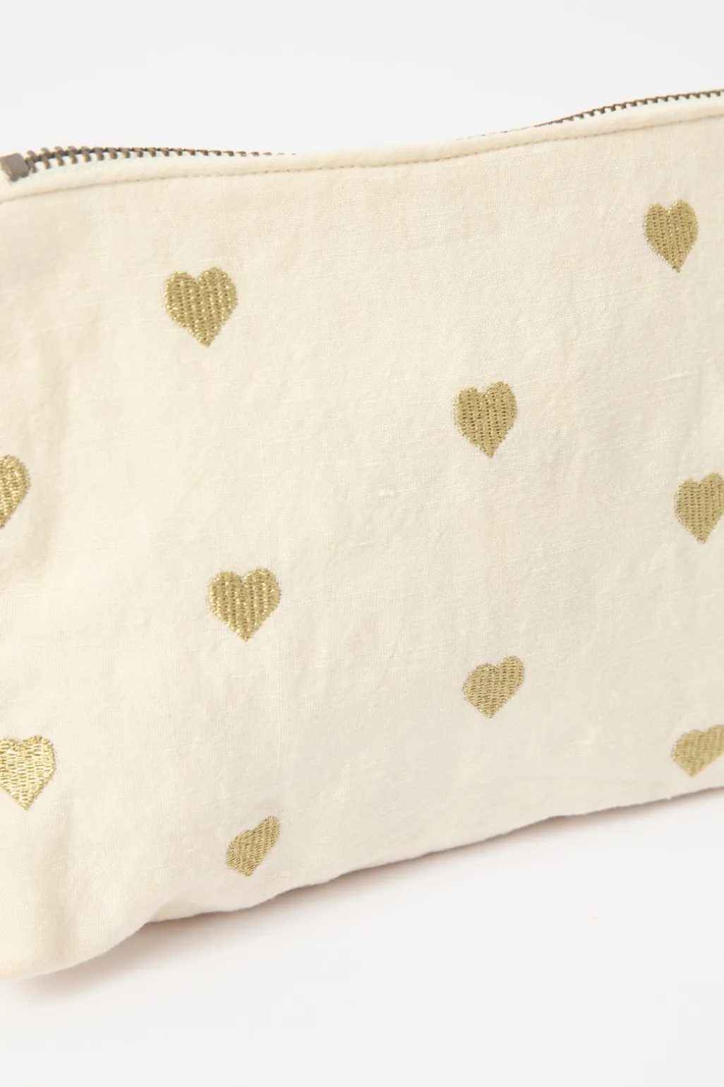 Crèmekleurige toilettas met gouden hartjes
