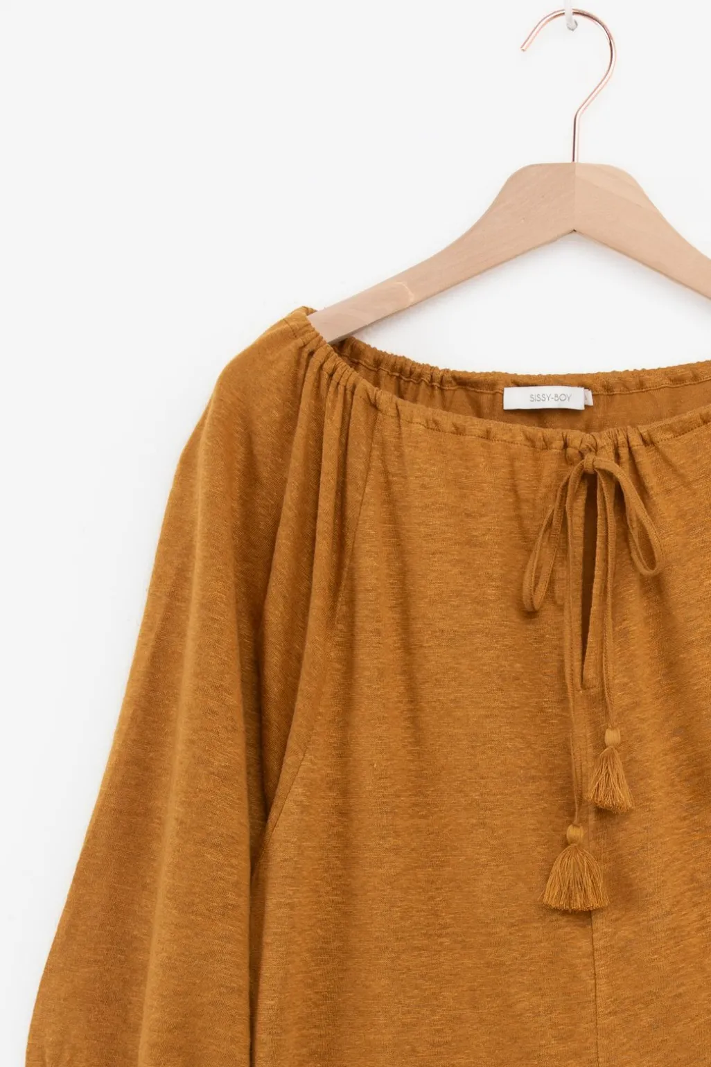 Goudbruine top met kwastjes